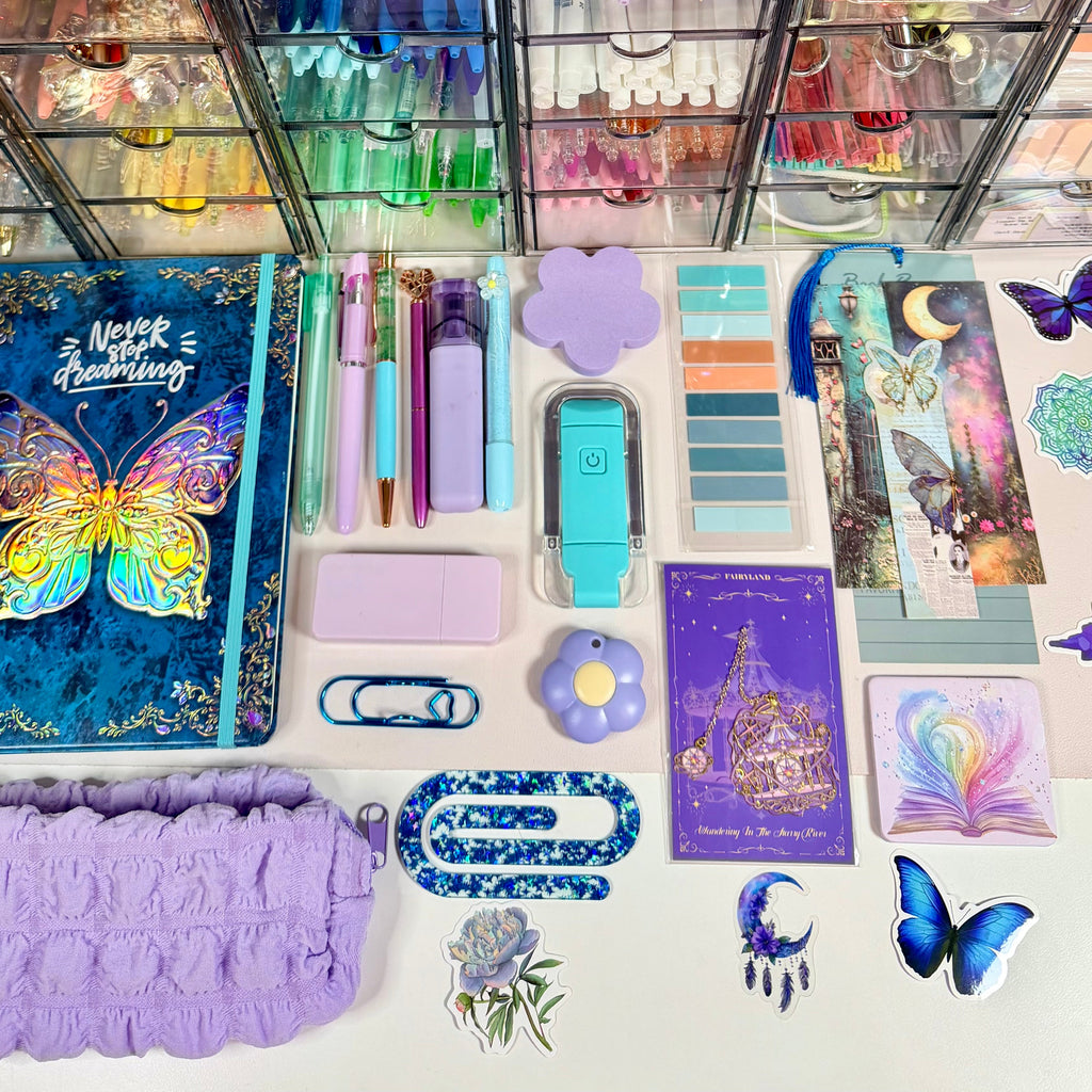 Butterfly Dreamscape bundle contents arranged flat with butterfly journal, lavender pouch and pastel stationery
