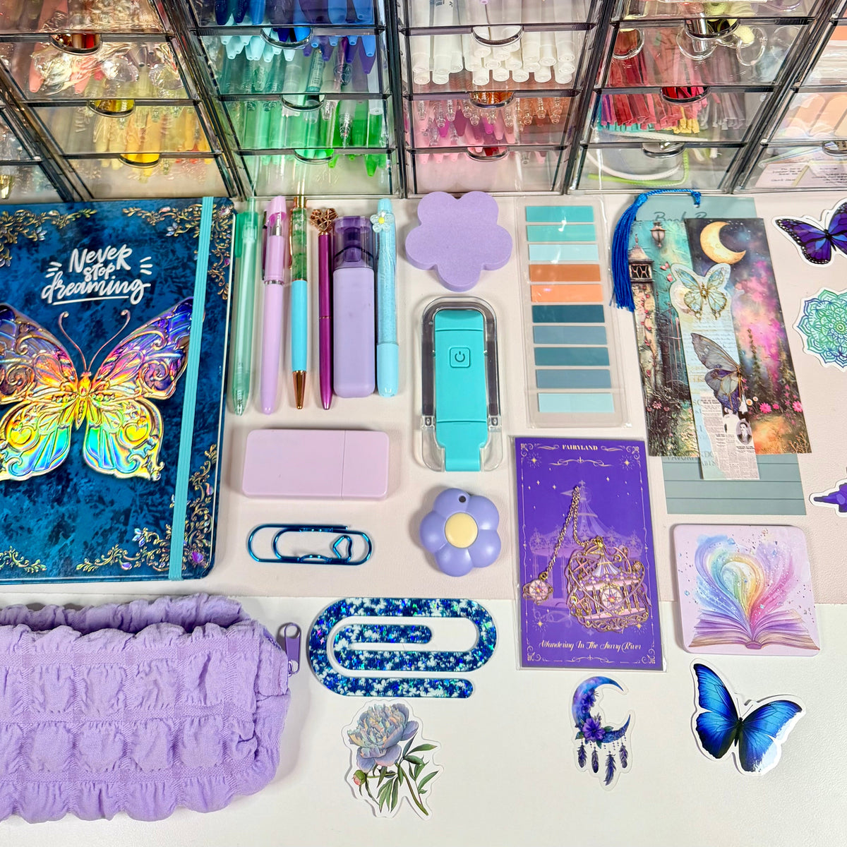 Butterfly Dreamscape bundle contents arranged flat with butterfly journal, lavender pouch and pastel stationery