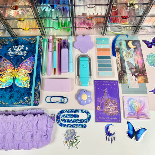 Butterfly Dreamscape bundle contents arranged flat with butterfly journal, lavender pouch and pastel stationery
